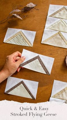 someone is working on some quilts that are sitting on a table with the words quick and easy stroked flying geese