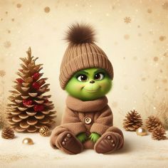 a green stuffed animal sitting next to a christmas tree and small pine cone on the ground