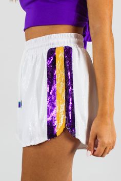 CATCHING WINS SEQUIN SHORTS IN WHITE BY QUEEN OF SPARKLES Purple And Gold Spirit Day Outfits, Gold Spirit Day, Spirit Day Outfits, Lsu Gameday, Spirit Day, Queen Of Sparkles, Day Outfits, Cozy Tops, Popular Bags