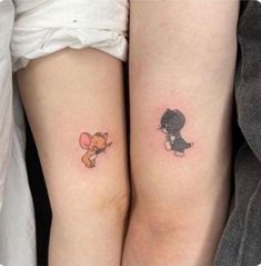 two small tattoos on the legs of people, one with a cat and mouse tattoo