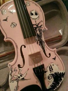 a pink violin with an image of jack skellingy on it's back