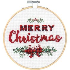 a cross stitch christmas ornament hanging from a hoop