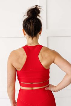 Introducing the Revive Crop - the perfect combination of style and function. Made with our soft ribbed fabric and 4-way stretch, this crop top is designed to keep you comfortable during your workouts. The built-in bra provides medium-impact support while the edgy and sleek cutout wraps around your midsection to accentuate the smallest part of your back, while still providing ample coverage.We listened to your requests and added more coverage than a typical crop, making it almost reach our High R Functional Crop Top With Built-in Bra For Pilates, Functional Crop Top With Built-in Bra For Workout, High Stretch Crop Top With Built-in Padding For Workout, Functional Workout Crop Top With Built-in Bra, Sporty High Stretch Crop Top With Built-in Padding, Compressive Crop Top With Built-in Padding For Workout, Red High Stretch Sports Bra With Built-in Support, Versatile Crop Top Sports Bra For Gym, Functional Compressive Crop Top For Yoga