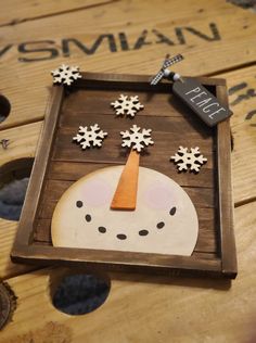 a wooden box with an image of a snowman on it