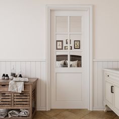 a bathroom with white walls and wood flooring next to an open door that leads into a bedroom