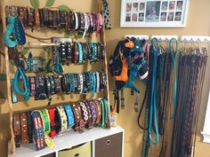 a room with many different types of bracelets on the wall and hanging from hooks