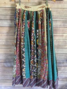 Sail away with this Around the World Skirt! This full maxi skirt features an eclectic mix of vibrant prints that'll put a spring in your step! Made of a comfy and adjustable material, it'll fit your waist like a glove, while the flouncy hem is sure to draw "oohs" and "aahs"! Slay the statement piece that is your life with this perfect one-size-fits-all skirt! fits sizes 2-16- has a zipper on the side with an adjustable tie drawstring waist model is a size 2/4, 5'6" tall 100% cotton each skirt is Flowy Patchwork Tiered Maxi Skirt, Green Bohemian Maxi Skirt With Boho Print, Flowy Tiered Patchwork Maxi Skirt, Bohemian Multicolor Boho Print Maxi Skirt, Flowy Patchwork Maxi Skirt, Spring Festival Patchwork Maxi Skirt, Spring Festival Maxi Skirt With Patchwork, Multicolor Boho Print Tiered Maxi Skirt, Bohemian Bottoms With Vibrant Print For Spring