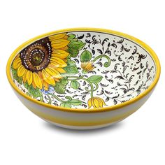 a yellow and white bowl with a large sunflower on the side, sitting in front of a white background