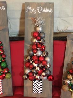 three wooden christmas trees with ornaments on them