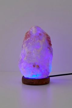 a purple rock sitting on top of a wooden stand