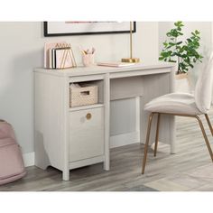 a white desk and chair in front of a wall with a painting on the wall