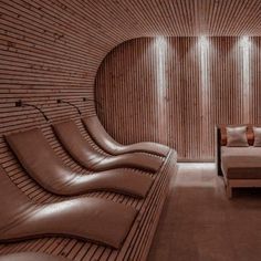 a room that has some couches and a bed in it with wooden slats on the walls