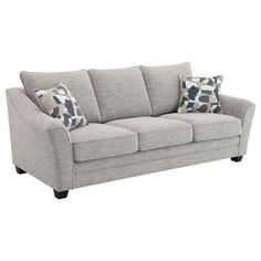 a gray couch with two pillows on it