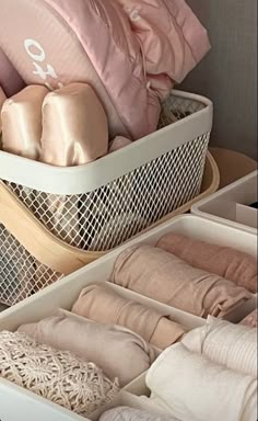 two baskets filled with pillows and blankets on top of each other