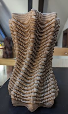 a wooden sculpture sitting on top of a table