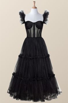 Turn heads in this timeless black corset dress! The A-line silhouette and tulle material create a soft, feminine look while the semi-transparent corset and ruffle straps add a hint of edgy elegance. The lace-up back and tea length complete the whimsical design. Black Corset Dress With Sheer Fitted Bodice, Black Corset Dress With Sheer Bodice, Black Sleeveless Tulle Corset Dress, Sleeveless Black Tulle Corset Dress, Black Overbust Dress For Prom, Gala Corset Dress With Ruffles And Fitted Bodice, Black Corset Dress With Boned Bodice For Gala, Sleeveless Tulle Corset Dress With Ruffles, Party Overbust Corset Dress With Ruffles