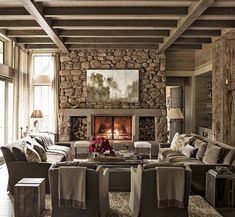 a living room filled with furniture and a fire place in the middle of a room