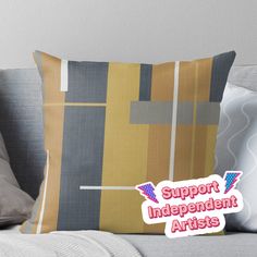 a pillow that has the words support independent artists in pink and yellow colors on it