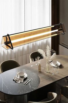 a dining room table with chairs and a light hanging over it