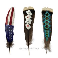 three different colored feathers with playing cards on them