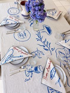 the table is set with blue and white place settings