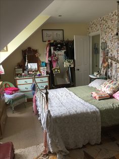 a bedroom with a bed, dressers and other items on the wall in it