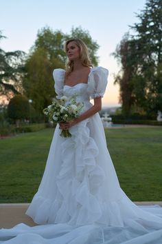 a woman in a wedding dress holding a bouquet