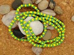 "Beautiful Handmade Elkes for Orula These are made with green and yellow beads Approx. 32\" in length (when opened) 16\" in length when tied" Green Beaded Chain Bracelets For Beach, Adjustable Yellow Single Strand Beaded Necklaces, Adjustable Yellow Single Strand Beaded Necklace, Adjustable Single Strand Yellow Beaded Necklaces, Adjustable Single Strand Yellow Beaded Necklace, Green Beaded Necklaces For The Beach, Green Hand-strung Necklace For Festivals, Green Hand-strung Jewelry For Festivals, Green Round Bead Necklaces For The Beach