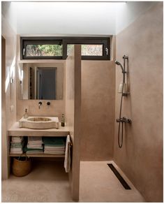 a bathroom with a sink, mirror and shower stall in it's own area