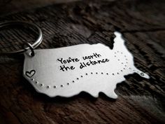 a metal keychain that says you're worth the distance