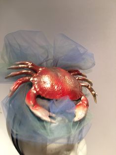 Sea food Festival- Crab Festival - Crab Hat- Beach Headpiece- Wedding - Shell headband- Beach headpiece- Mermaid costume Hello, This fascinator can be worn at a beach wedding, birthday, Derby or for a mermaid costume. It's made with a plastic Crab. It is 2 inches high and diameter is 7 inches wide. One of a kind...each one is a little different. Netting is shown in blues like water but can be in other colors....just ask. It's crab is finished with a metallic gold dusting so make it sparkle a bit Red Crab, Large Brim Hat, Derby Horse, Types Of Hats, Mermaid Costume, Sea Food, Headpiece Wedding, Fascinator Hats, A Mermaid