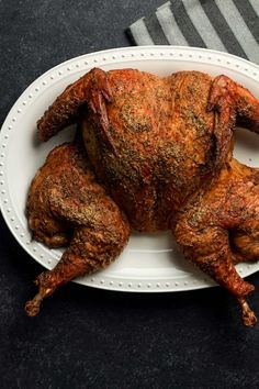 a whole chicken on a white plate with the words smoked spartahcock turkey above it