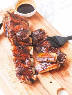 barbecue ribs on a cutting board with sauce