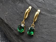 Gold Emerald Earrings set with a Created Emerald in a flawless diamond cut & clarity, deep green color, at 10x8mm, 6 Carats a pair. Dangling Earrings made of Gold Vermeil ☞ thickest 18k Gold Plating on Solid 925 Sterling Silver ☞ made to last. Click here for ☞ Matching RingClick here for ☞ Matching Pendant Details:♥ Created Emerald in a flawless clarity and deep green color,♥ Garnet: 10x8mm, 3 Ct, Diamond cut♥ Lever Back Closure - "English Lock"♥ Height 17mm, Width 8mm♥ 18k Gold VermeilSKU 2828( Formal Green Diamond Cut Earrings, Emerald Earrings With Diamond Cut For Gift, Emerald Diamond Cut Earrings Gift, Green Teardrop Earrings With Prong Setting, Classic Green Diamond Cut Earrings, Elegant Green Diamond Cut Earrings, Gold Emerald Earrings, Deep Green Color, Earrings Emerald