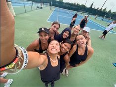 a group of women standing on top of a tennis court