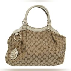 211944 520981 Brown G G Canvas Trimmed In Ivory Leather And Featuring Gold Tone Hardware. Includes Gg Charm. Gucci Bag, Satchel, Gold Tones, Bag Lady, Gucci, Cream, Leather, Gold, Color