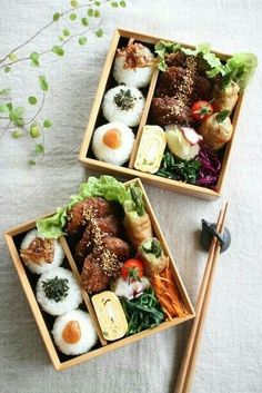 two wooden boxes filled with different types of food