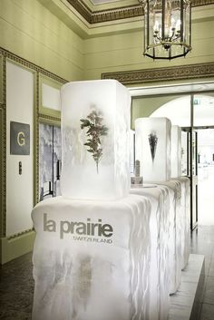 an ice sculpture in the middle of a hallway with chandelier hanging from it's ceiling