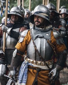 a group of men dressed in armor standing next to each other