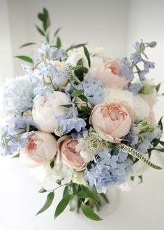 a bouquet of blue and white flowers on a table