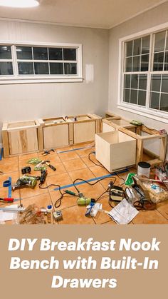 an unfinished room with boxes and tools on the floor in front of windows that read diy breakfast nook bench with built - in drawers