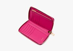 Elegant streamlined and in a just-right size our Katy zip-around wallet is done in textured leather with its signature glossy logo plaque. | Kate Spade Katy Medium Zip-Around Wallet, Wild Raspberry Affordable Elegant Kate Spade Wallets, Cheap Kate Spade Wallets With Card Slots, Glossier Logo, Hot Bags, Festival Shop, Kate Spade Wallet, Summer Essentials, Continental Wallet, Zip Around Wallet