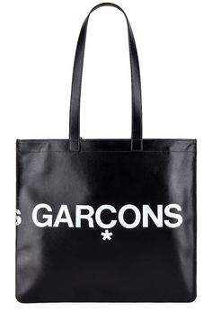 Find COMME DES GARÇONS Huge Logo Tote Bag on Editorialist. COMME des GARCONS Huge Logo Tote Bag in Black Smooth cow leather with twill lining. Made in Spain. Double shoulder straps measures approx 25 in length with a 10 drop. Measures approx 14W x 13H x 0.25D. Interior zip pocket. Printed logo detail. Gold foil logo detail. CMEX-UY39. SA9001HL. About the designer: The often avant-garde and always influential label was created by Kawakubo in Tokyo in 1969 before heading to Paris in 1981 where it garnered both acclaim and controversy with a debut collection of distressed and deconstructed pieces. The modern Comme des Garçons brand, which encompasses anentire family of sub-brands in fashion and fragrance, is worn by men and women who like to take an esoteric style stance. Black Calf Leather Shoulder Bag With Smooth Grain, Black Calf Leather Bag With Removable Pouch, Black Calf Leather Bag For Daily Use, Designer Black Bags With Smooth Grain, Black Shoulder Bag With Leather Lining And Coated Canvas, Modern Bag With Leather Lining And Coated Canvas, Modern Coated Canvas Bag With Leather Lining, Black Calf Leather Shopping Bag, Designer Black Shoulder Bag With Smooth Grain