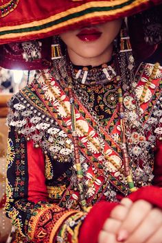 a woman wearing an elaborate hat and jewelry