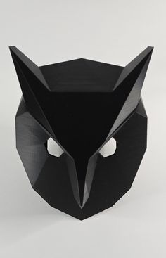 an origami cat mask is shown in black