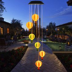 an outdoor walkway with lanterns hanging from it