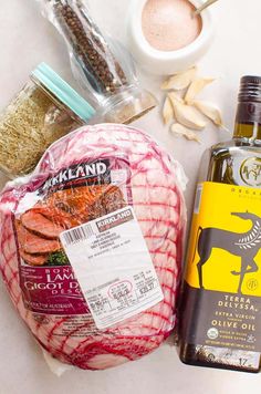 ingredients to make an italian dish laid out on a counter top, including meat and seasoning