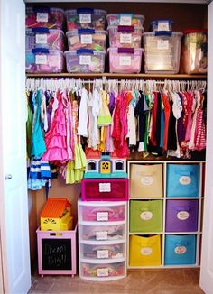 the closet is filled with lots of colorful drawers and bins for children's clothes