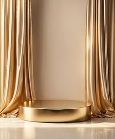 an empty room with gold curtains and a round table