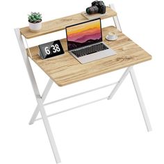 a laptop computer sitting on top of a wooden desk next to a clock and plant